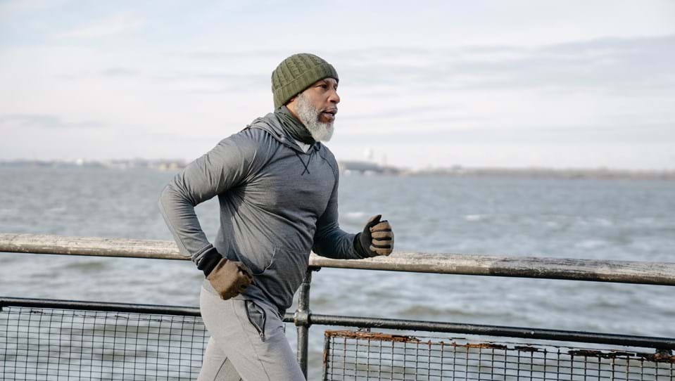 A man jogging by the coast