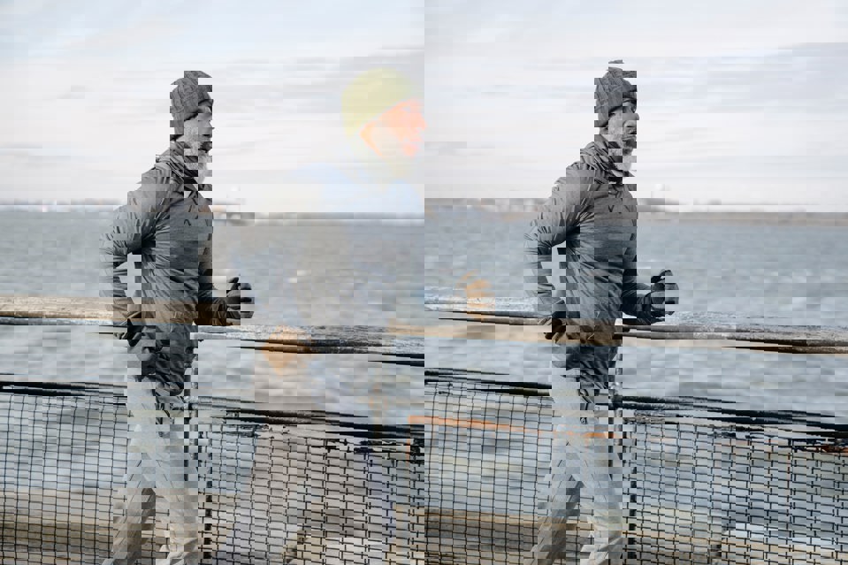 A man jogging by the coast