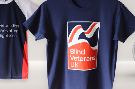 A variation of Blind Veterans UK branded t-shirts and a mug