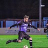 Action shot of Matt in his purple football kit on the pitch