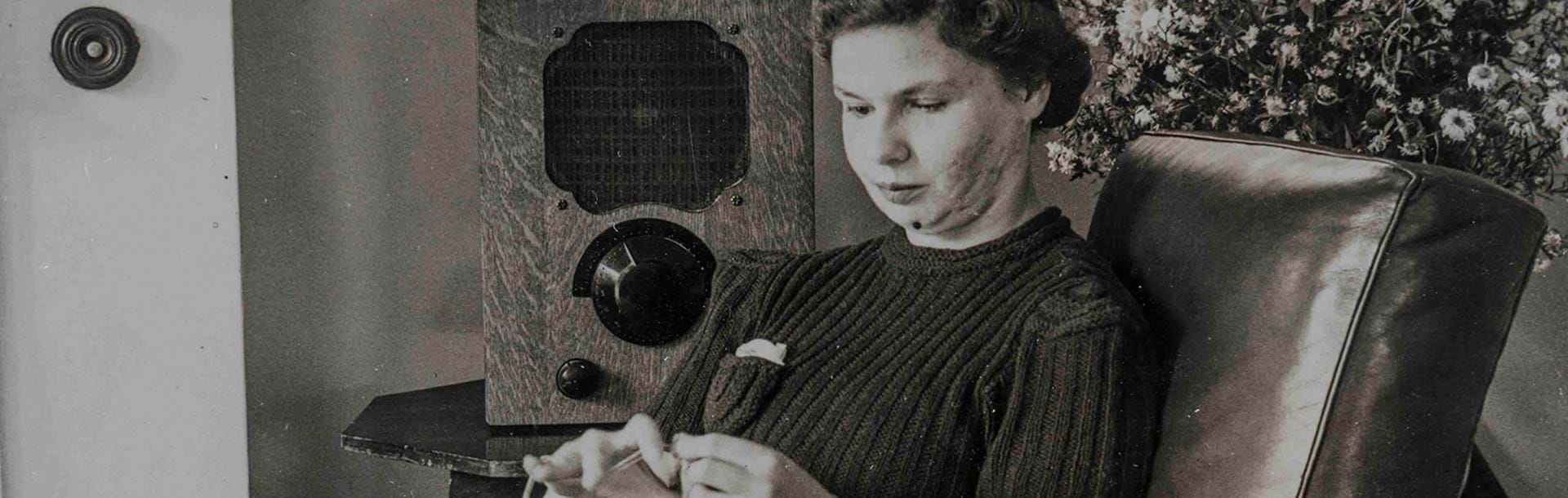 A black and white photo of Barbara Bell a blind veteran sewing