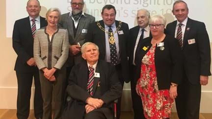 Photo of Dr Zbigniew Pełczyński OBE, front centre, pictured with our Chief Executive Nick Caplin, back left, and other guests at the presentation ceremony