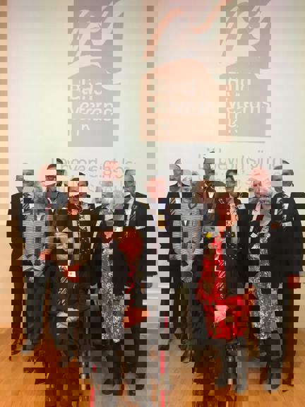 Photo of Dr Zbigniew Pełczyński OBE, front centre, pictured with our Chief Executive Nick Caplin, back left, and other guests at the presentation ceremony