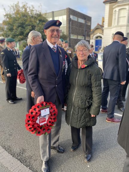 A photo of blind veteran Bob and wife Margaret holding wreath at Remembrance ceremony