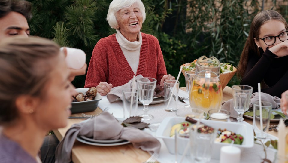 A photo of a happy family enjoying dinner in garden