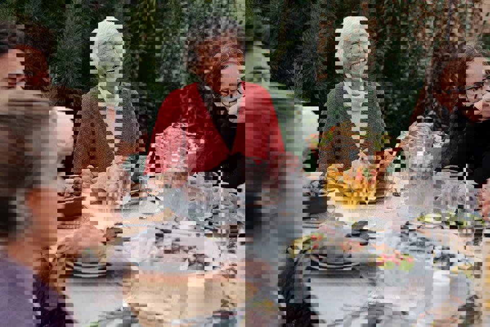 A photo of a happy family enjoying dinner in garden