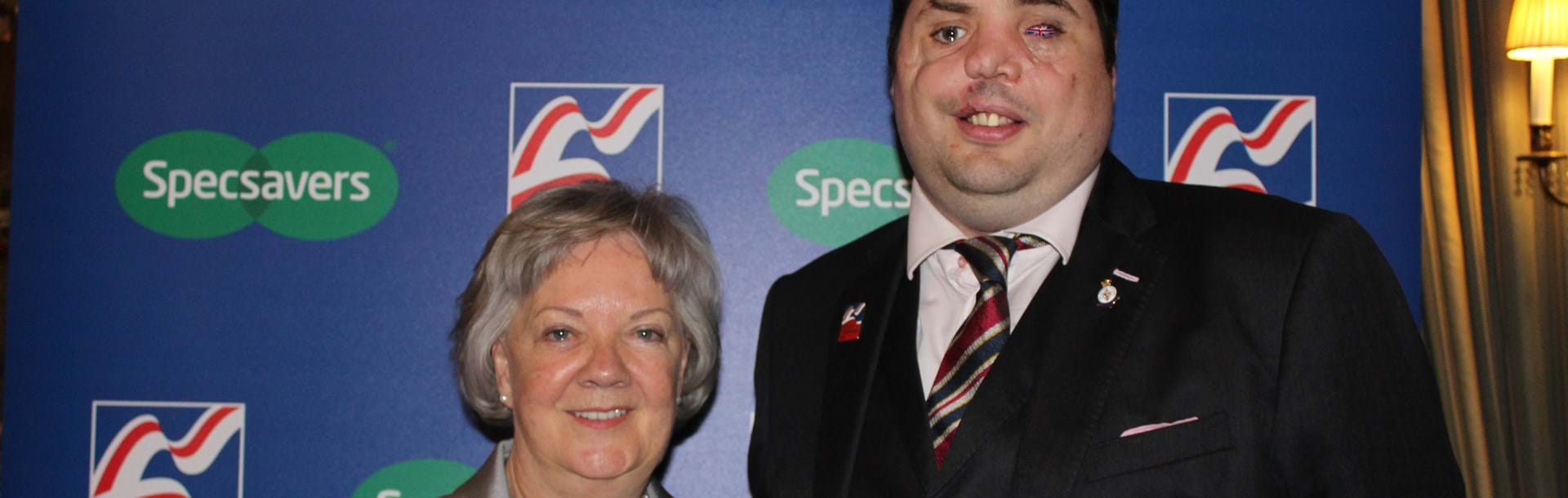 A photo of Dame Mary Perkins of Specsavers and Simon Brown Blind Veteran
