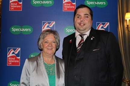 A photo of Dame Mary Perkins of Specsavers and Simon Brown Blind Veteran