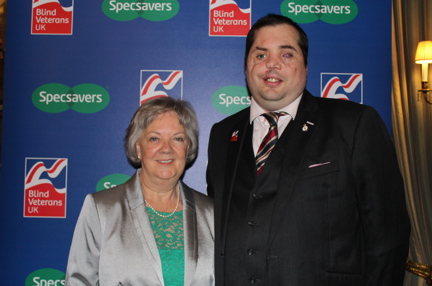 A photo of Dame Mary Perkins of Specsavers and Simon Brown Blind Veteran