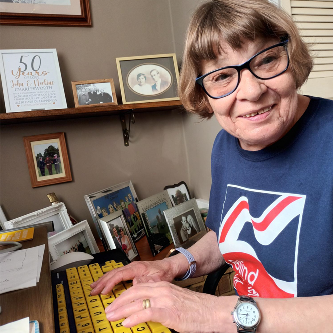 A photo of blind veteran Noeline using an adapted keyboard