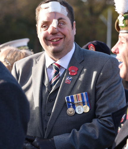 A photo of Simon wearing his medals at a Remembrance event in London in 2016