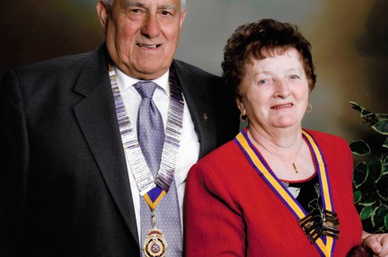 A head-shot of Bob and his late wife dressed smartly, wearing their medals and smiling