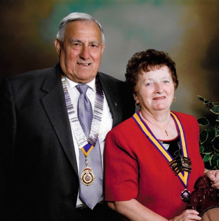 A head-shot of Bob and his late wife dressed smartly, wearing their medals and smiling