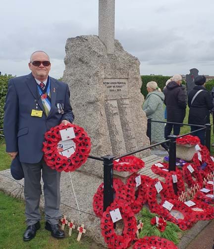 Blind veteran Ray laying a wreath at Westgate-on-Sea standing next to the war memorial