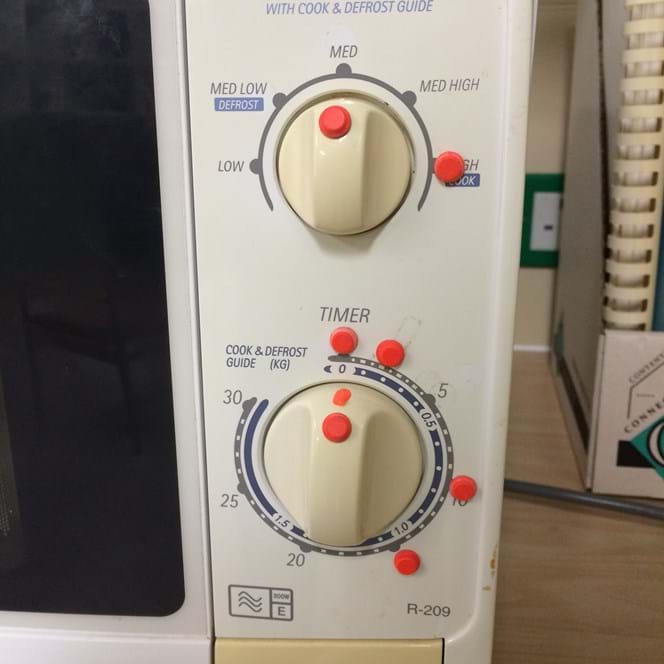 Bumpons placed on the dial of a microwave as markers