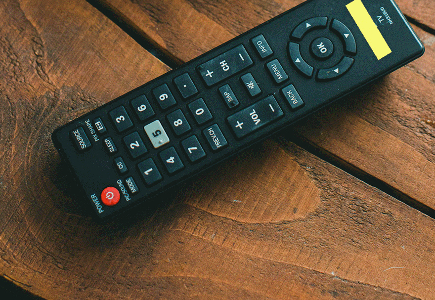 A TV remote with bright yellow highlighter tape