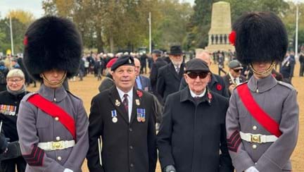 Photo of blind veteran Billy with Guardsmen waiting to start the march at the Cenotaph