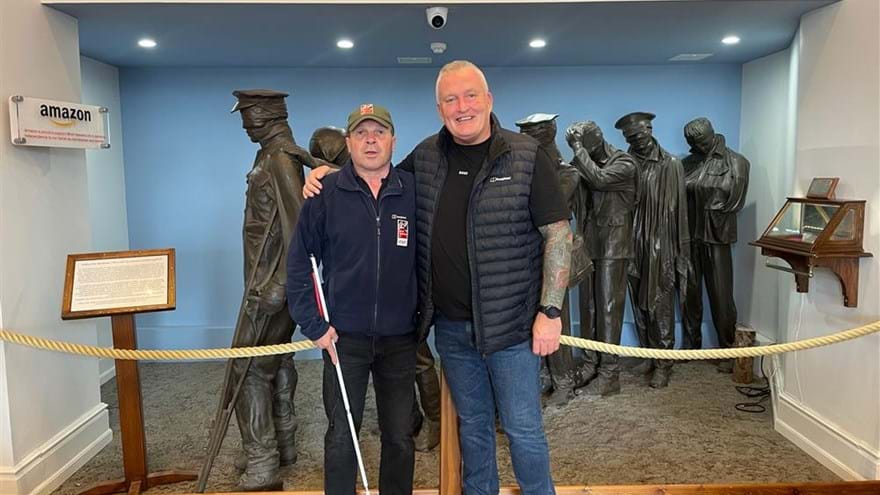 Billy and Colin stood in front of the Victory over Blindness statue at the Llandudno Centre