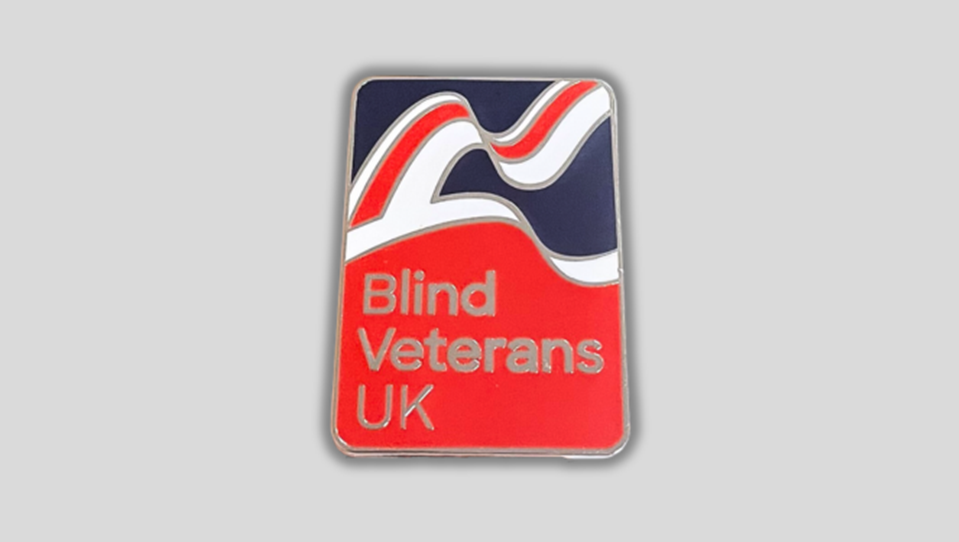 a Blind Veterans UK pin badge