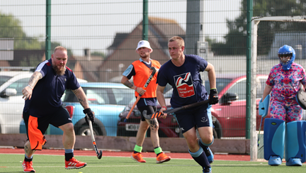 Player running towards the ball wearing a Blind Veterans UK t-shirt