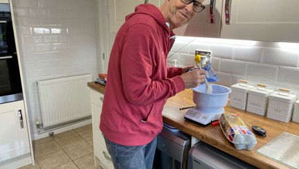 Blind veteran Mike in his kitchen using specially adapted equipment to bake