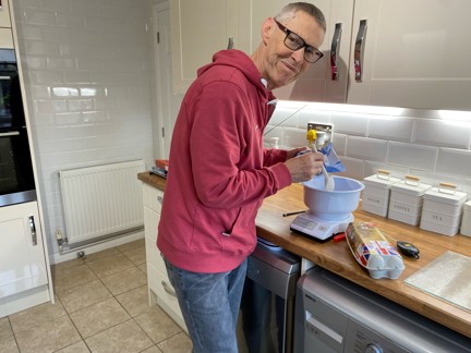 Blind veteran Mike in his kitchen using specially adapted equipment to bake