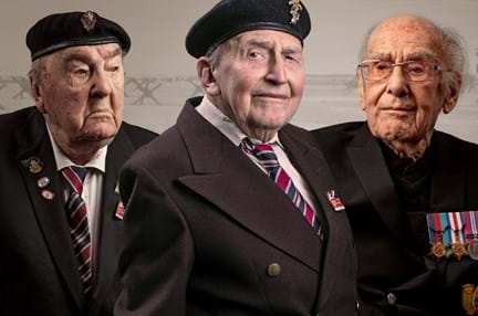 A photo of blind veterans Richard, John, and Harry edited over a Normandy beach