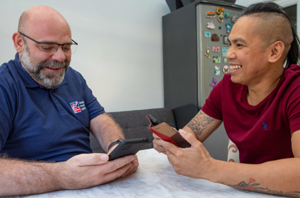 Blind veteran Ken being taught to use a smart phone