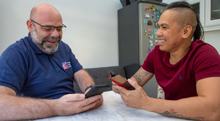 Blind veteran Ken being taught to use a smart phone