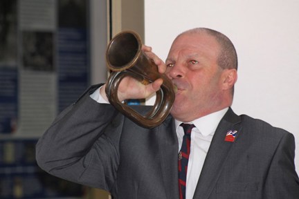 Blind veteran Billy blowing into a trumpet