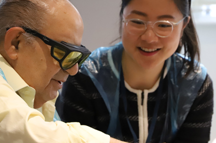 A blind veteran and volunteer smiling at an Easter themed activity day