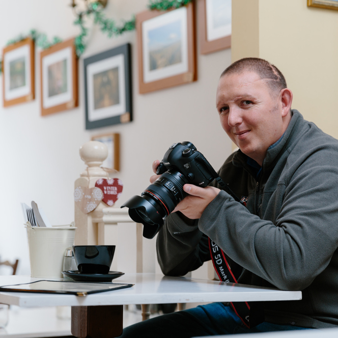 A photo of Chris a blind veteran using a camera