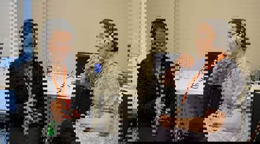 Two students with headphones on test the game