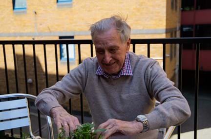 A photo of blind veteran Bob gardening at Harcourt Street