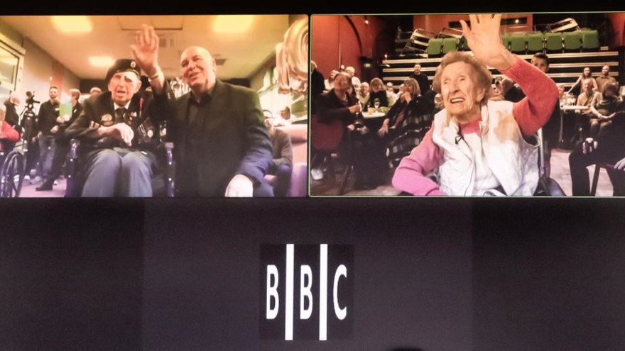 A screen showing blind veterans Ken and Margaret on their 100th birthdays