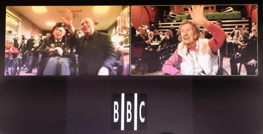A screen showing blind veterans Ken and Margaret on their 100th birthdays