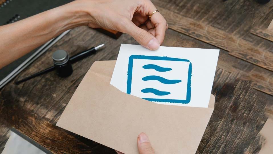 Hands placing a cheque icon into an envelope