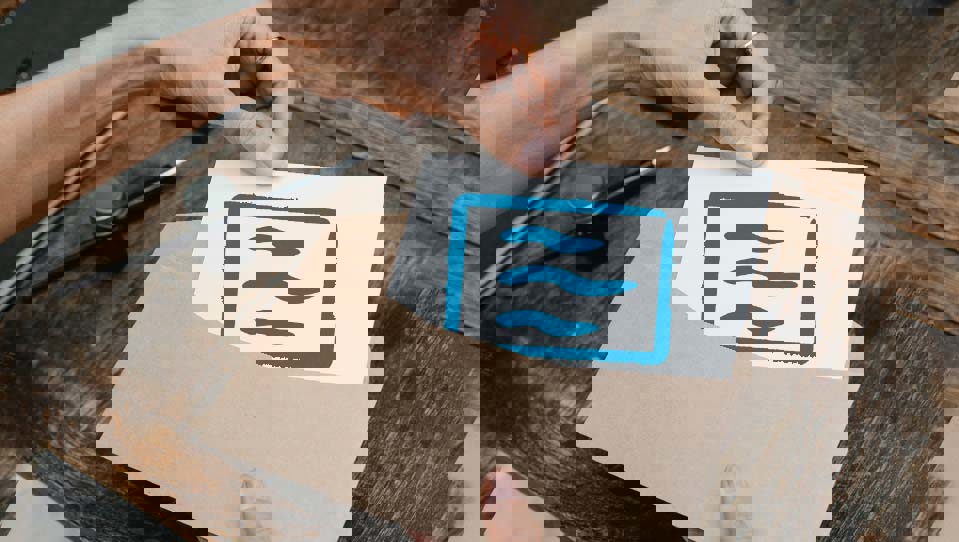 Hands placing a cheque icon into an envelope
