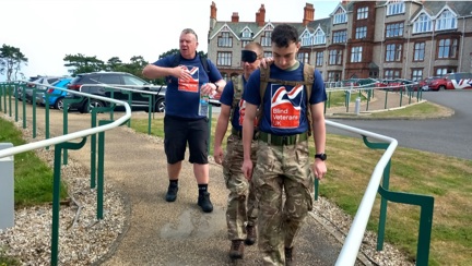 Heading out with the Llandudno Centre in the background. One person is guiding his blindfolded colleague.