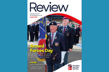 A magazine front cover with title "Armed Forces Day" and an image of a blind veteran acting as standard bearer at an event with a Blind Veterans UK flag