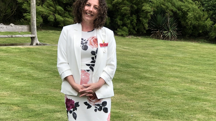 Photo of Blanche, Residential Care Manager, smiling and standing in front of Brighton centre