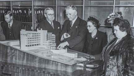 The scale model of the Brighton centre, with blind veterans gathered round 