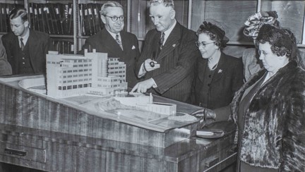 The scale model of the Brighton centre, with blind veterans gathered round 