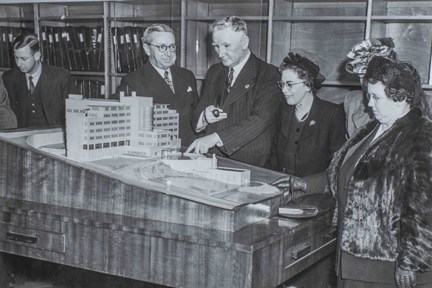 The scale model of the Brighton centre, with blind veterans gathered round