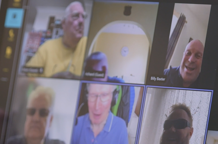 A photo of a computer screen where a group of blind veterans are using Microsoft teams