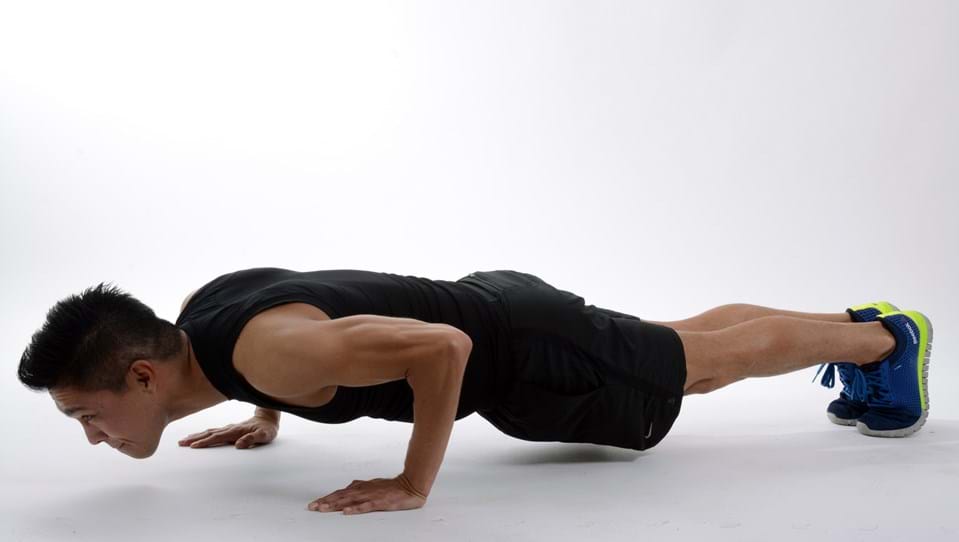 A photo of a man doing a push up