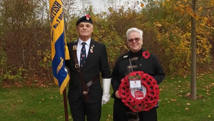 A photo of community support worker Anne (right) with blind veteran and standard bearer Wayne at the funeral of Geoffrey John Barker