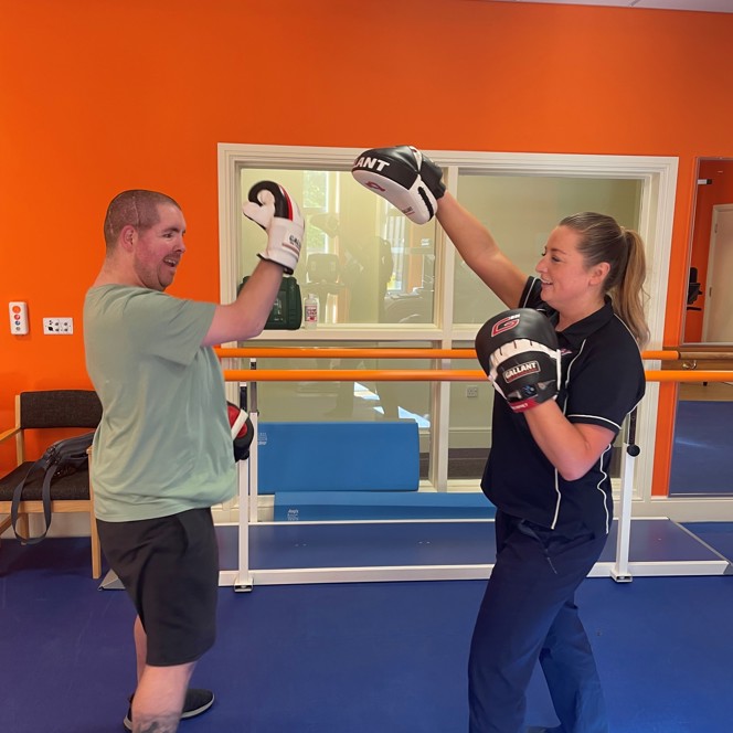 John wearing boxing gloves and taking part in a boxing session