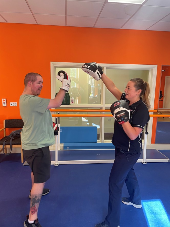 John wearing boxing gloves and taking part in a boxing session