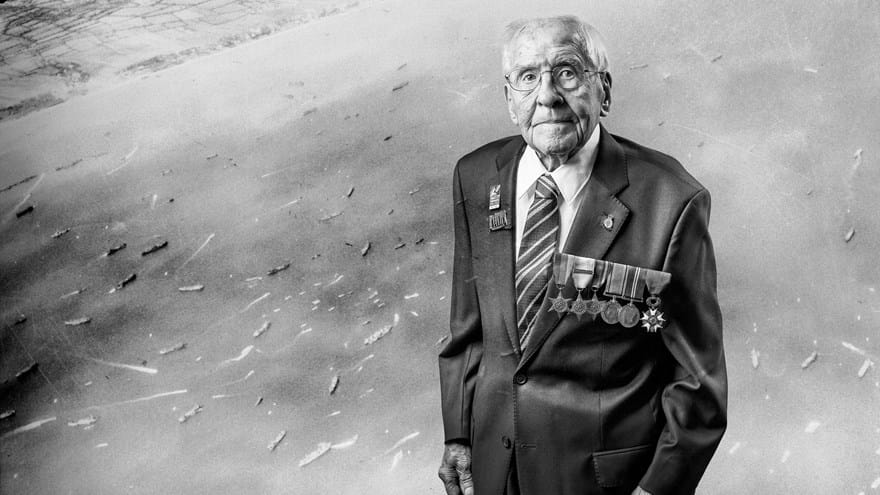 A black and white portrait of blind veteran Thomas, overlaid on a scene from D-Day